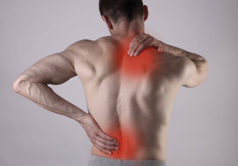 Man Holding His Back In Pain